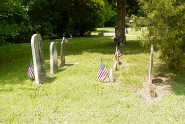 American flags decorate some stones in Eglington Cemetery